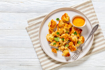 baked Cauliflower florets with sauce on plate