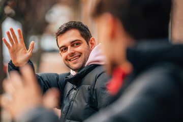 friends on the street greeting each other