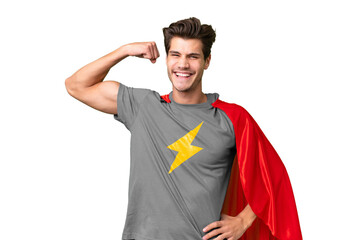 Young handsome caucasian man over isolated background in superhero costume and doing strong gesture