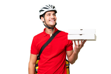 Pizza delivery man with work uniform picking up pizza boxes over isolated background thinking an...