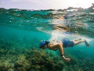 woman snorkeling in clear tropical sea