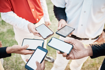 Hands, phone and communication with a baseball team outdoor on a sport field for strategy or tactics before a game. Teamwork, fitness and networking with a group of people sharing sports information