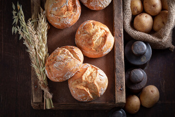 Tasty and fresh potato buns in rustic cellar.