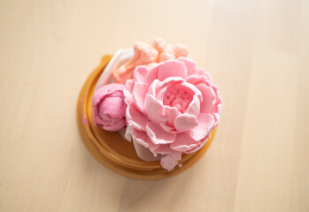 sweet dessert, marshmallow in the shape of a pink peony flower on a light background. Sugar addiction, consumption, handmade dessert. Low calorie marshmallows, carbs