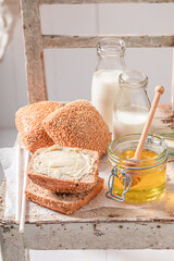 Tasty buns with honey with milkshake for breakfast.