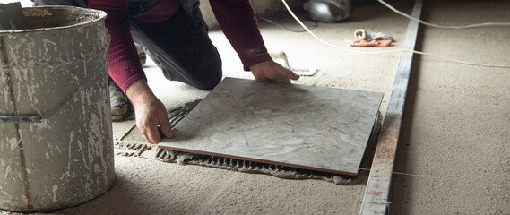 Laying floor ceramic tile. Renovating the floor