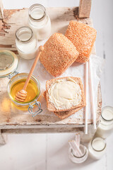Healthy buns with honey and milk in bottle.