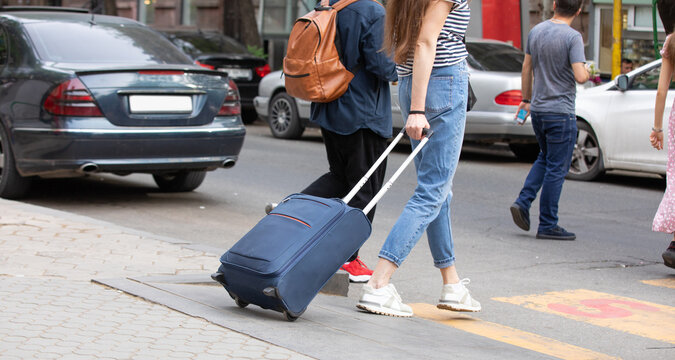 Girl with luggage on a city street. Travel. Vacation