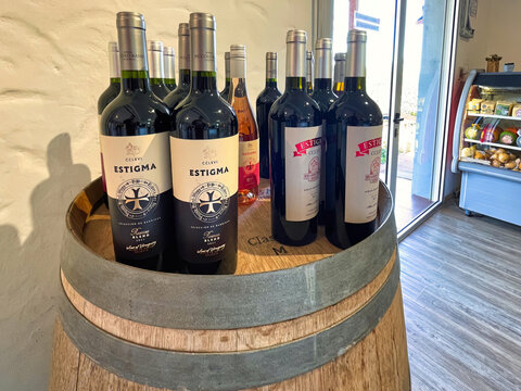 wine in bottles on wine barrel - nueva helvecia, uruguay - November 1 2022