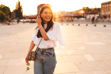 Young charming woman portrait in the city at sunset