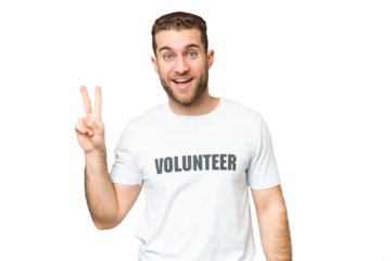 Young volunteer man over isolated chroma key background smiling and showing victory sign