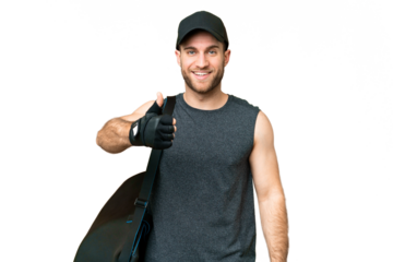 Young sport man with sport bag over isolated chroma key background with thumbs up because something good has happened