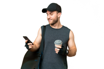 Young sport man with sport bag over isolated chroma key background holding coffee to take away and a mobile
