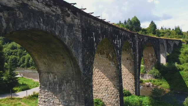 Vorokhta, Ukraine - June 2021: Old railway bridge, old viaduct Vorohta, Ukraine. Carpathian Mountains, wild mountain landscape.
