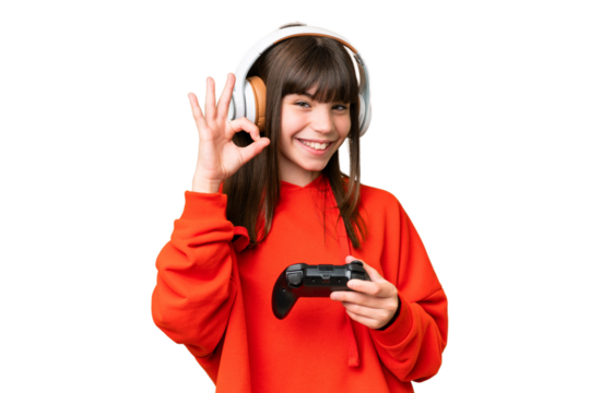 Little caucasian girl playing with a video game controller over isolated background showing ok sign with fingers