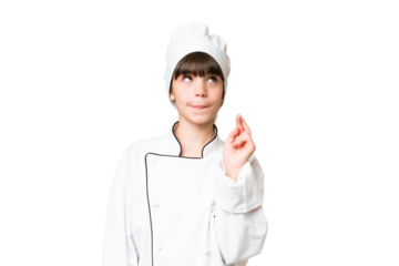 Little caucasian chef girl over isolated background with fingers crossing and wishing the best