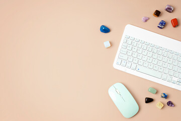 Healing chakra crystals and computer keyboard. Online application for rituals with gemstones for...