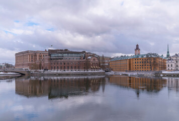 The canals Stallkanalen and Str&ouml;mmen, the Parliament and government buildings, a grey snowy day in Stockholm