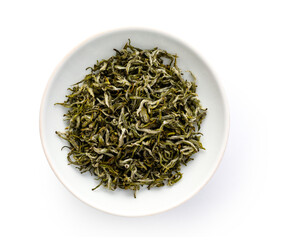 Some green tea dry tea samples in a porcelain dish.
