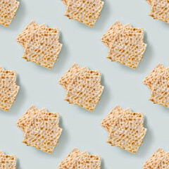 Seamless pattern of traditional Jewish kosher matzo for Passover on blue background. Pesach Jewish holiday.
