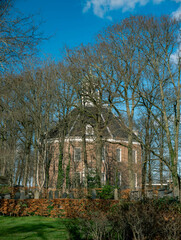 Old cemetery and protestant church behind the trees