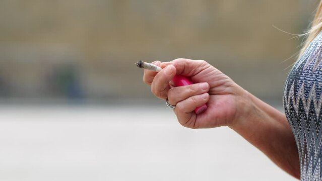 senior woman smokes a cigarette
