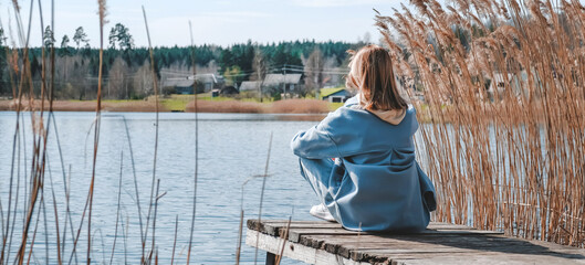 travel,adventure,Rest on the lake. A young girl traveler is resting near the water. Eco travel, local travel. Relax, meditation near the water.