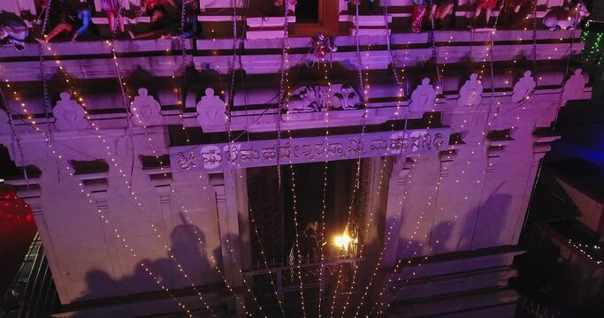 An aerial tracking view of the temple tower or gopuram with sculptures