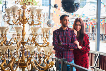 A beautiful Indian married couple is walking in a European city. A stylish place in the Urban style. Love and joyful relationships.