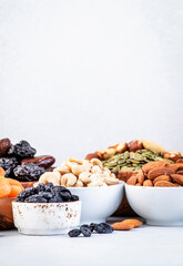 Nuts and dried fruits. Healthy snacks. Dried apricots, figs, raisins, pecans, walnuts, hazelnuts, almonds and other. Gray table background