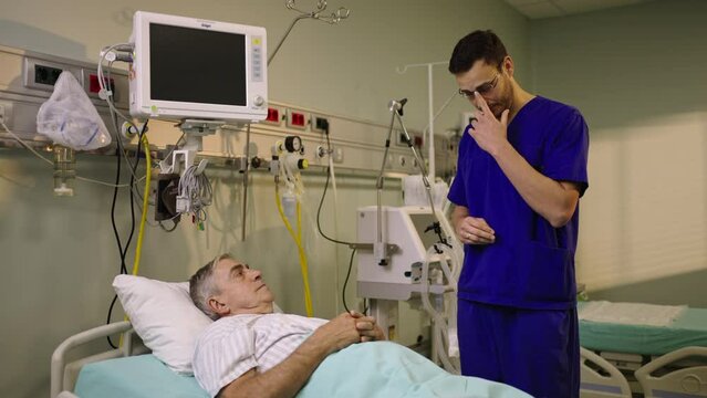 Male professional doctor explaining health condition to mature patient in the hospital. Shot in slow-motion