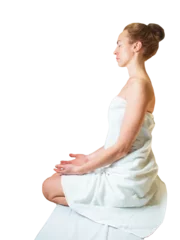 Wall murals Massage parlor woman sits in a lotus position in a towel on a white background, preparing for a massage session, meditation,