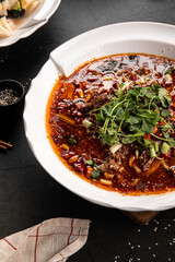 Portion of chinese szechuan beef dish on black wooden background