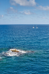 Fototapeta premium Photo of two beautiful sailboats crossing the open sea