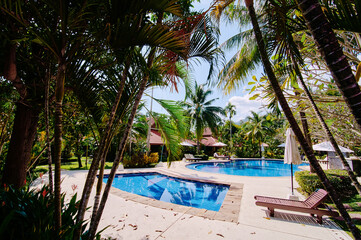 Tropical resort. Swimming pool and bungalow.