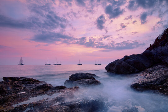 Sea landscape with sunset sky and boats on the horizon