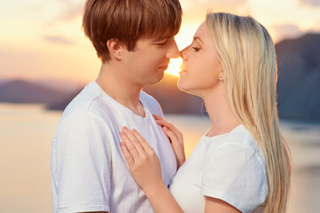 Love and romance. Honeymoon on the sea shore. Beautiful loving couple embracing on the beach
