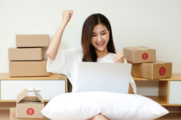 Smart Asian young woman SME working with a box at home. small business owner entrepreneur SME and delivery concept.