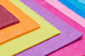 Multi-colored soft felt textile material, colorful patchwork texture fabric close-up