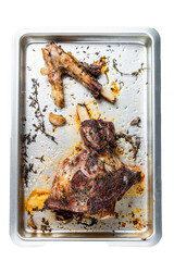 Roasted lamb mutton whole leg in a baking dish.   Isolated, transparent background
