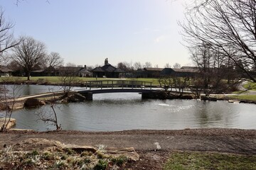 Fototapeta na wymiar The wood bridge over the pond in the park.