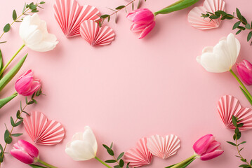 Mother's Day concept. Top view photo of pink white tulips and origami paper hearts on isolated...