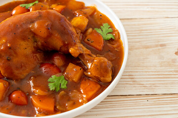 chicken stew with tomatoes, onions, carrot and potatoes