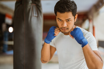 a boxer seriously punching the heavy bags at the boxing studio