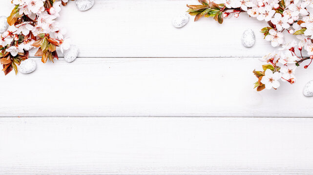 Easter white background. Spring flower border, white happy easter egg on wooden spring background. Easter card. Flat lay.