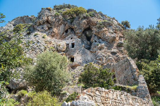 Ruins of Afkule monastery carved into rocks by the Mediterranean coast near Kayakoy village in Mugla province of Turkey.