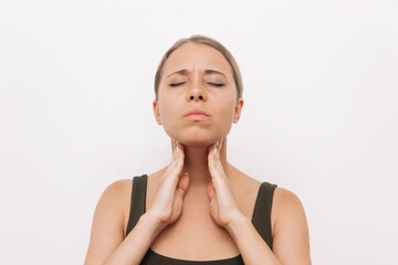 Fototapeta na wymiar Young caucasian blonde woman with throat ache touches enlarged lymph nodes under jaw on her neck isolated on white background. Flu, cold, covid, tonsillitis, sars virus, inflamed tonsils. Sore throat