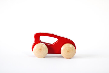 Red wooden car. Children's toy on a white background