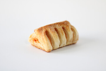 Bakery pastries with ham and cheese close-up. The concept of a delicious breakfast. Isolated over white background