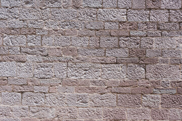Brick wall, beige shell rock. Repeating stone texture background.